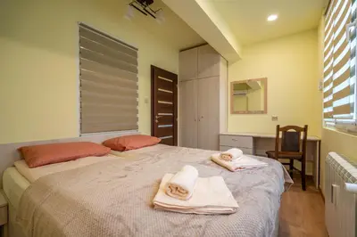 a bedroom with a large bed with towels on it at Top Location Central New & Spacious 3 BDR apt Medical Academy in Sofia