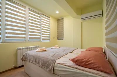 a bedroom with a bed with two towels on it at Top Location Central New & Spacious 3 BDR apt Medical Academy in Sofia