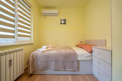 a small bedroom with a bed with a doll on a table at Top Location Central New & Spacious 3 BDR apt Medical Academy in Sofia
