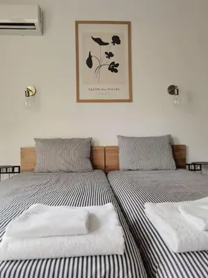 two beds in a bedroom with towels on them at The Courtyard 2Bdrm Apartment in Sofia