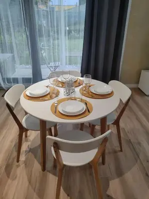 a white table with chairs and plates and wine glasses at The Courtyard 2Bdrm Apartment in Sofia