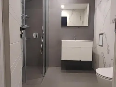 a bathroom with a shower and a sink and a toilet at The Courtyard 2Bdrm Apartment in Sofia