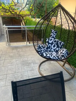 a swing with a vase in it next to a laptop at GreenBoxApartment in Kyustendil