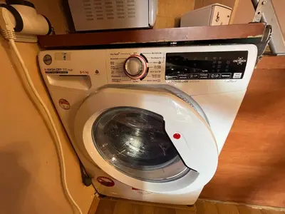 a washing machine with its door open in a room at Marina Apartment - Mountain View in Bansko