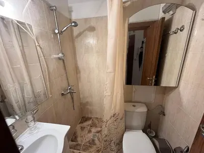 a bathroom with a sink and a toilet and a mirror at Marina Apartment - Mountain View in Bansko