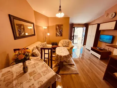 a living room with a couch and a table at Marina Apartment - Mountain View in Bansko