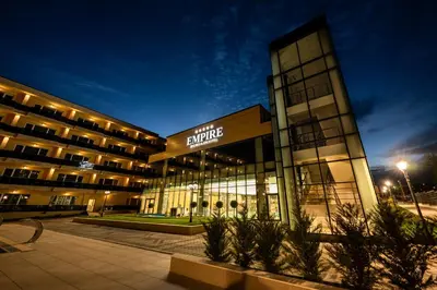 a building with a sign on the front of it at Empire Balneo & Spa Hotel in Hisarya