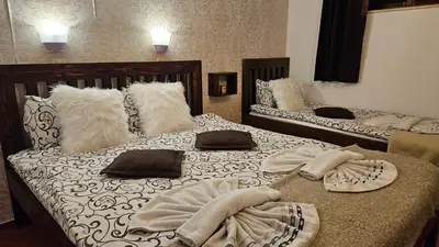 two beds with towels on them in a room at Bansko Prespa Ski Penthouse in Bansko