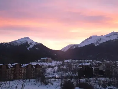 a city in the snow with mountains in the background at Bansko Prespa Ski Penthouse in Bansko