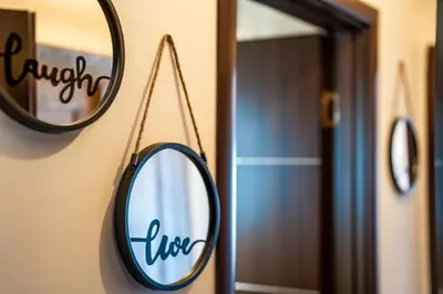 a mirror hanging on a wall next to a door at Private cozy at Alpin Lodge Studio + SPA Complex in Bansko