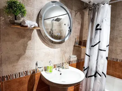 a bathroom with a sink and a mirror at Private cozy at Alpin Lodge Studio + SPA Complex in Bansko