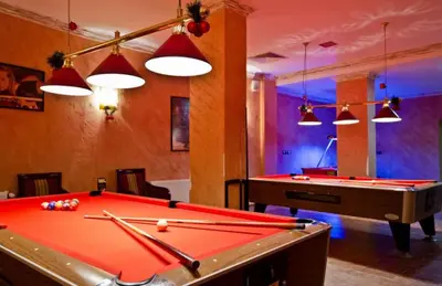 a billiard room with a pool table and lights at Grand Monastery Pamporovo Luxury Apartment in Pamporovo