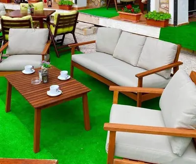 a group of chairs and a table and a couch at Grand Monastery Pamporovo Luxury Apartment in Pamporovo