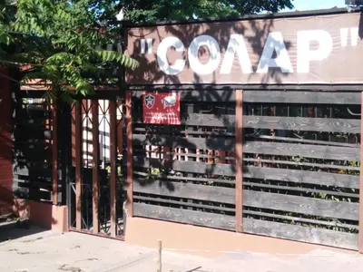 a gate to a store with a sign that reads in concert at Solar in Plovdiv