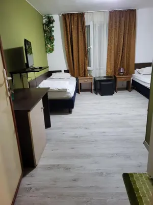 a hotel room with two beds and a desk at Solar in Plovdiv