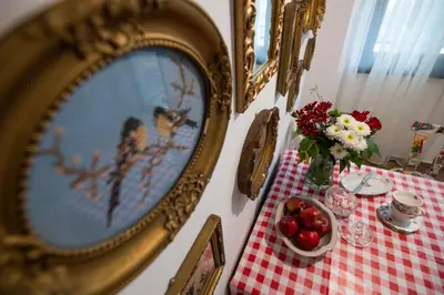 a table with a mirror and a table with flowers and fruit at SOTS apART in Sofia center in Sofia