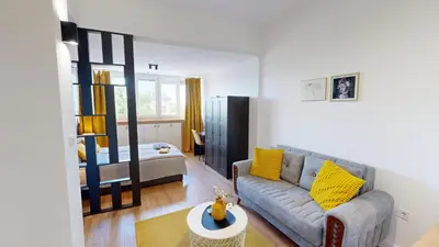 a living room with a couch and a bed at Modern City Stay apartment 4 min walk from Alexander Nevski in Sofia