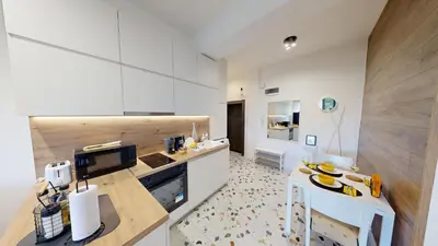 a kitchen with white cabinets and a counter top at Modern City Stay apartment 4 min walk from Alexander Nevski in Sofia