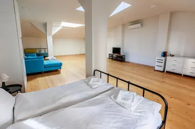 a bedroom with a bed and a living room at Saffron Guest House in Plovdiv