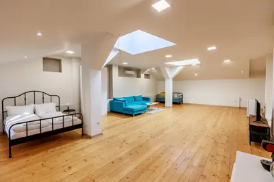 a bedroom with a bed and a living room at Saffron Guest House in Plovdiv