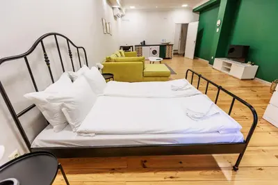 a hospital bed with white sheets and pillows in a room at Saffron Guest House in Plovdiv