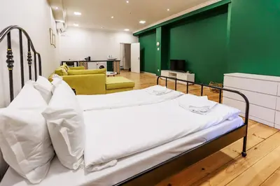 a hospital bed in a room with a green wall at Saffron Guest House in Plovdiv