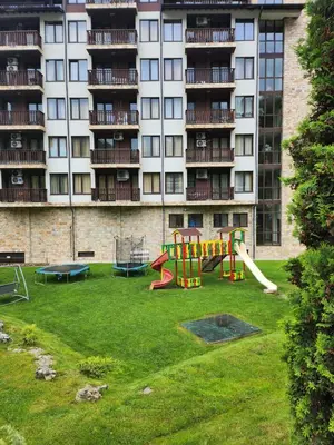 a playground in front of a large building at Студио Бети Балнео Спа Хотел Свети Спас in Velingrad