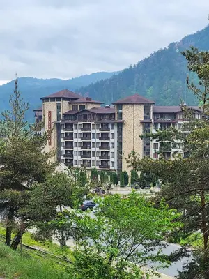 a large building with trees in front of it at Студио Бети Балнео Спа Хотел Свети Спас in Velingrad