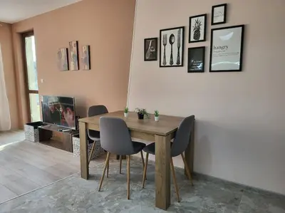 a dining room with a wooden table and chairs at Stylish apartment near City, entire flat, 1 bedroom, 1 large bed in living room in Plovdiv