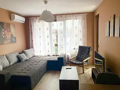 a living room with a couch and a chair at Stylish apartment near City, entire flat, 1 bedroom, 1 large bed in living room in Plovdiv