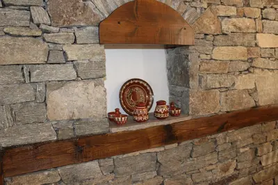a stone wall with a niche in a wall at Delchevata Kushta V Leshten in Leshten