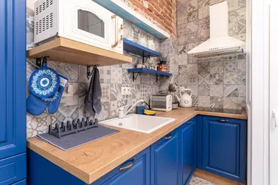 a kitchen with blue cabinets and a sink and a microwave at City Center Retro Chic Kapana 2-Bed Apartment in Plovdiv