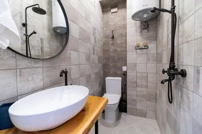a bathroom with a sink and a toilet and a mirror at City Center Retro Chic Kapana 2-Bed Apartment in Plovdiv