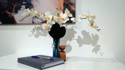 a vase with white flowers in it on a table at Modern Comfort near Airport, The Mall, TechPark by KeyBox in Sofia