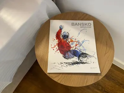 a book sitting on top of a wooden table at Apart house EMA 4 in Bansko