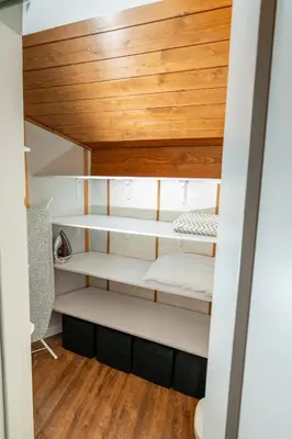 a room with white bunk beds with wood ceilings at Apart house EMA 4 in Bansko