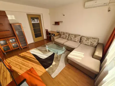 a living room with a couch and a glass table at Spacious 2 Bedroom Apartment in Sofia