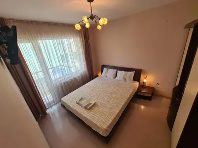 a bedroom with a bed and a large window at Spacious 2 Bedroom Apartment in Sofia