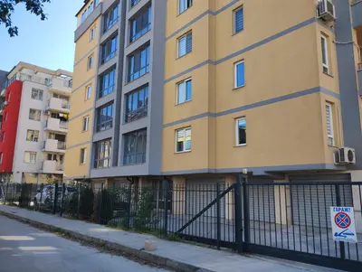 an apartment building with a fence in front of it at Happy Apartment & Free Breakfast - Mladost in Sofia