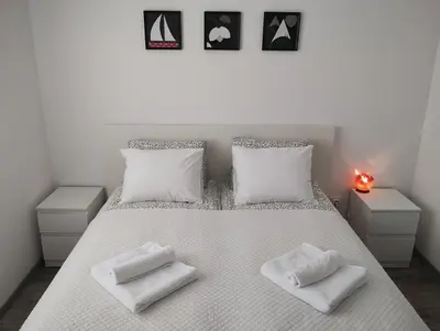 a bedroom with a white bed with two white pillows at Happy Apartment & Free Breakfast - Mladost in Sofia