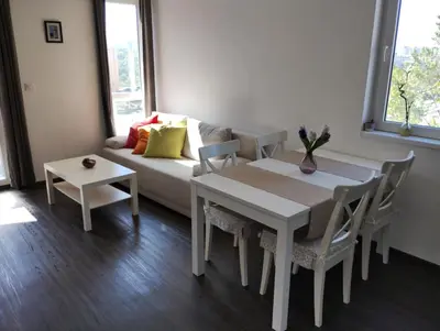a living room with a white table and a couch at Happy Apartment & Free Breakfast - Mladost in Sofia
