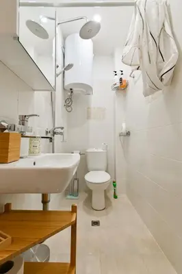 a white bathroom with a sink and a toilet at Apart Hotel Roma in Sofia