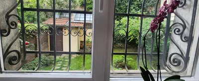 an open window with a view of a yard at Apart Hotel Roma in Sofia