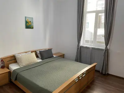 a bedroom with a bed and a window at The Central Post Apartments in Sofia