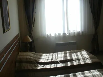 a bedroom with a bed in front of a window at Deluxe Room in Stoykite in Pamporovo