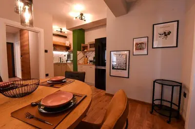 a kitchen and dining room with a table and chairs at Апартамент за гости Асеновец in Asenovgrad