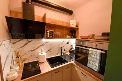 a kitchen with a counter with a sink and a stove at Апартамент за гости Асеновец in Asenovgrad