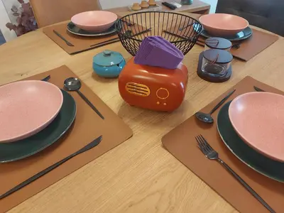 a table with plates and utensils on it at Апартамент за гости Асеновец in Asenovgrad