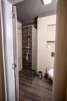 a bathroom with a shower and a toilet at Central & Quiet 2BR with Free Private Parking in Sofia