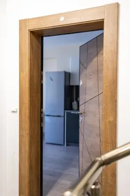 a glass door leading into a kitchen with a refrigerator at Central & Quiet 2BR with Free Private Parking in Sofia